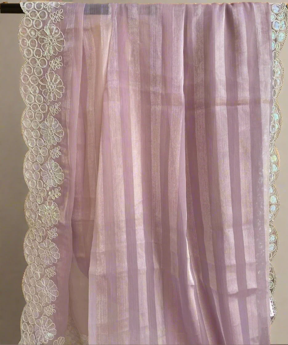 A purple floral saree with self-striped design and floral border detailing, displayed on a light background.