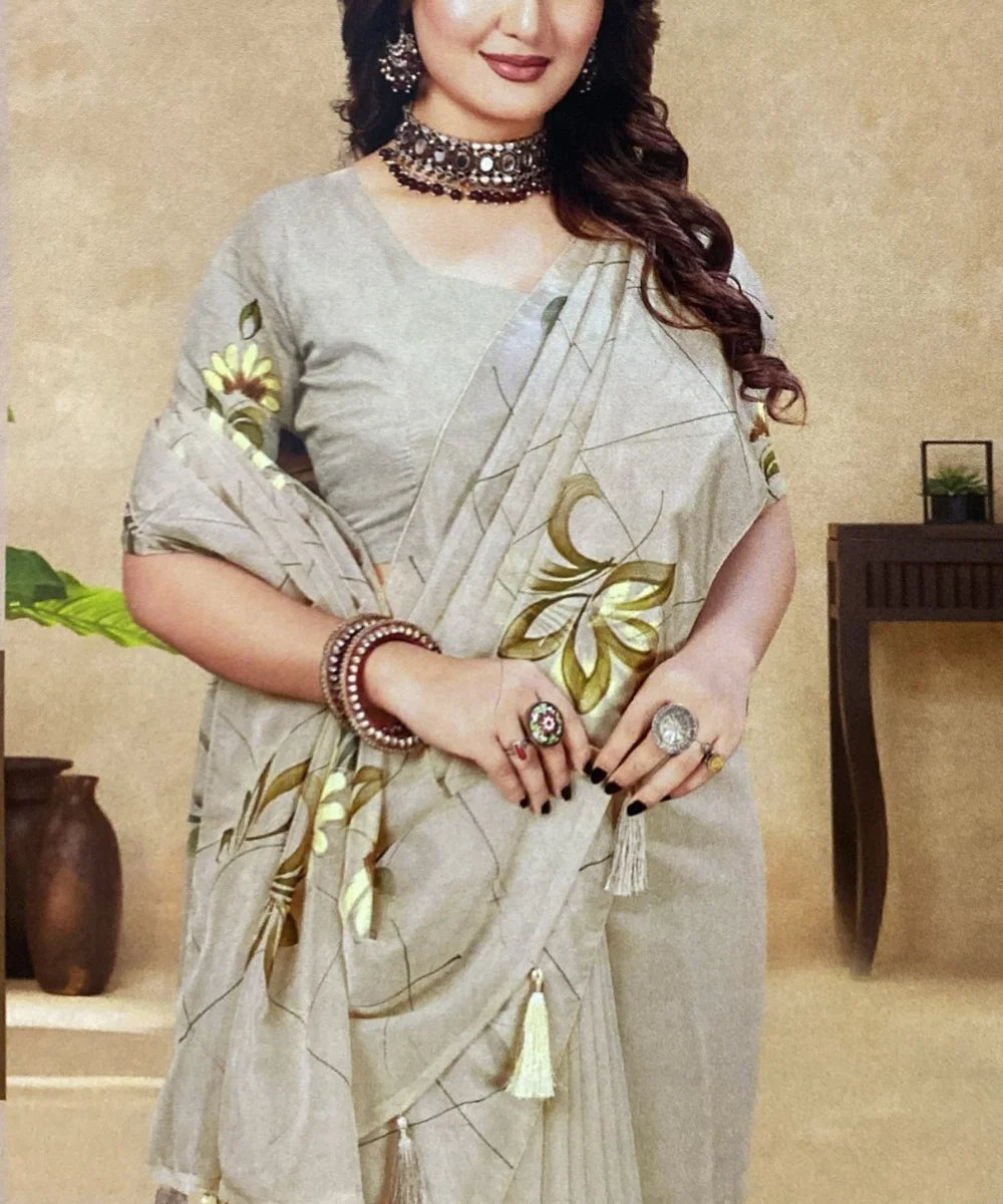 Woman wearing a gray saree with floral patterns indoors