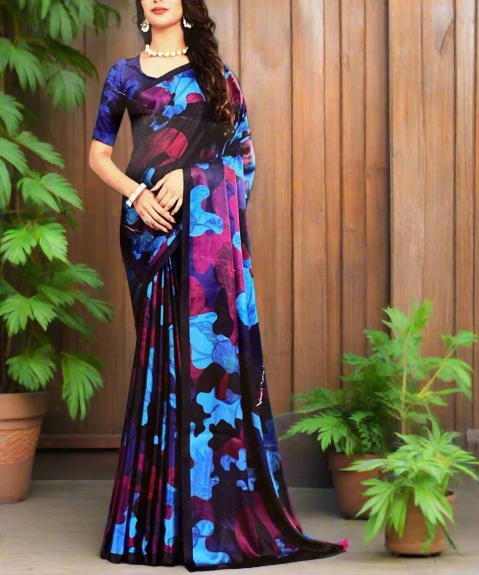 Woman wearing a colorful saree against a wall.