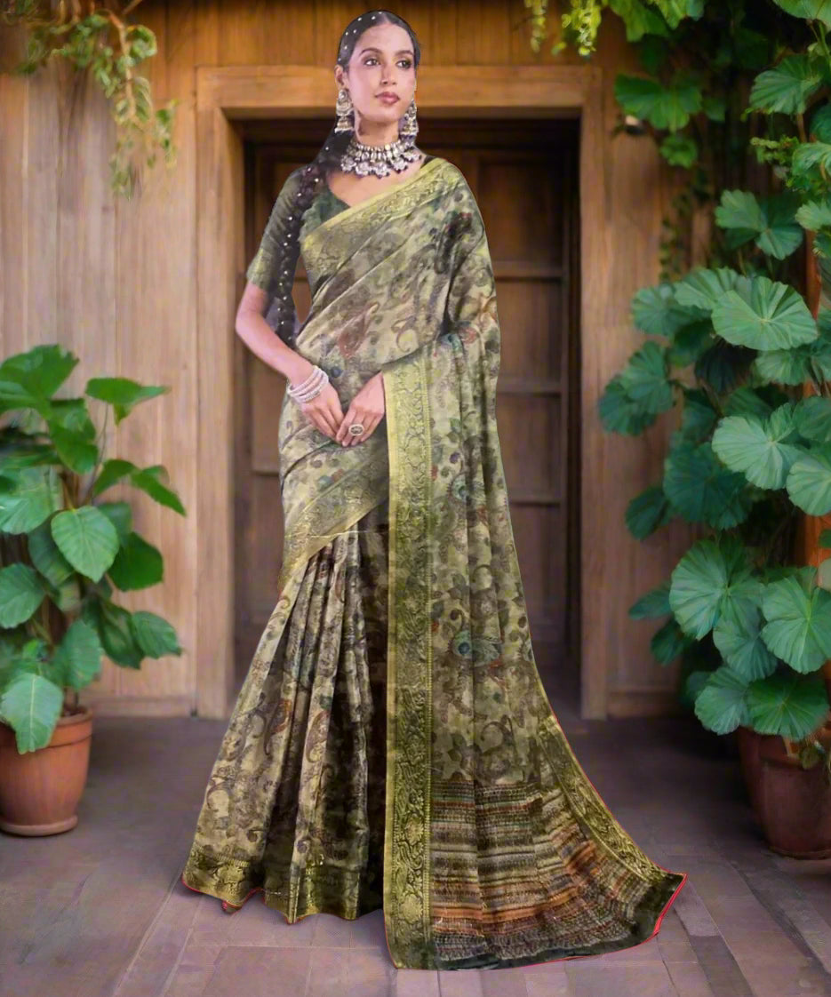 Woman wearing a green and black saree with a grey background