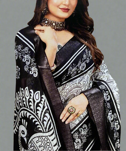 Woman wearing a black and white peacock print formal saree with a grey background