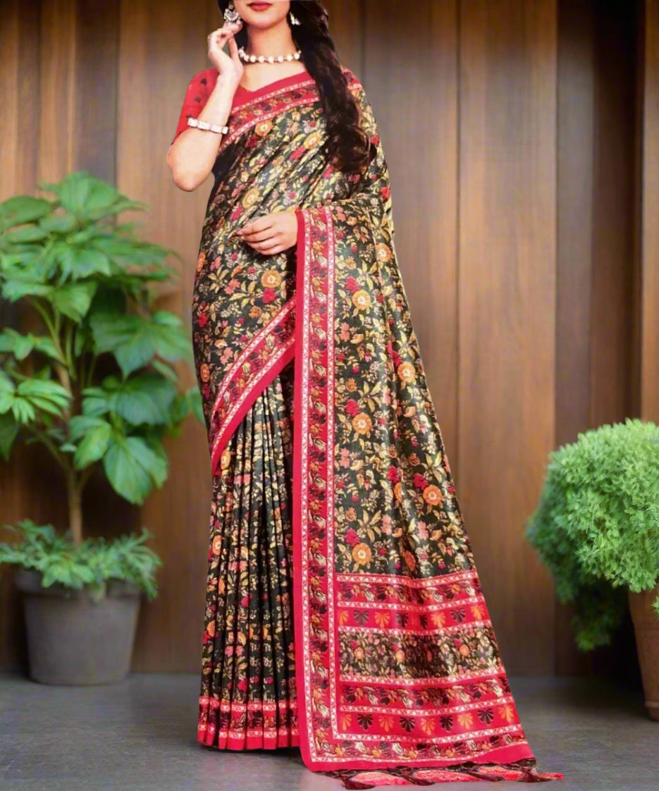 Woman wearing a traditional saree with a floral pattern against a grey background