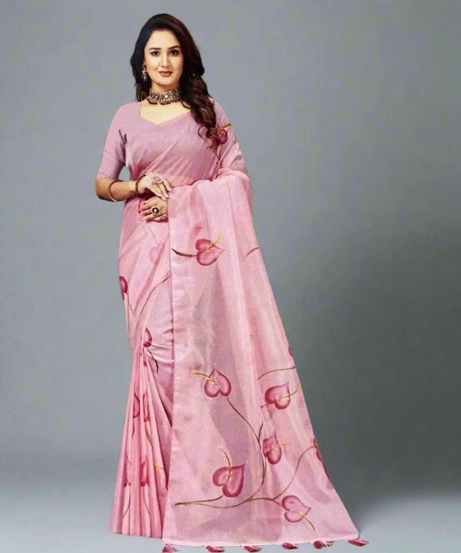 Woman wearing a pink hand-painted saree with leafy patterns.