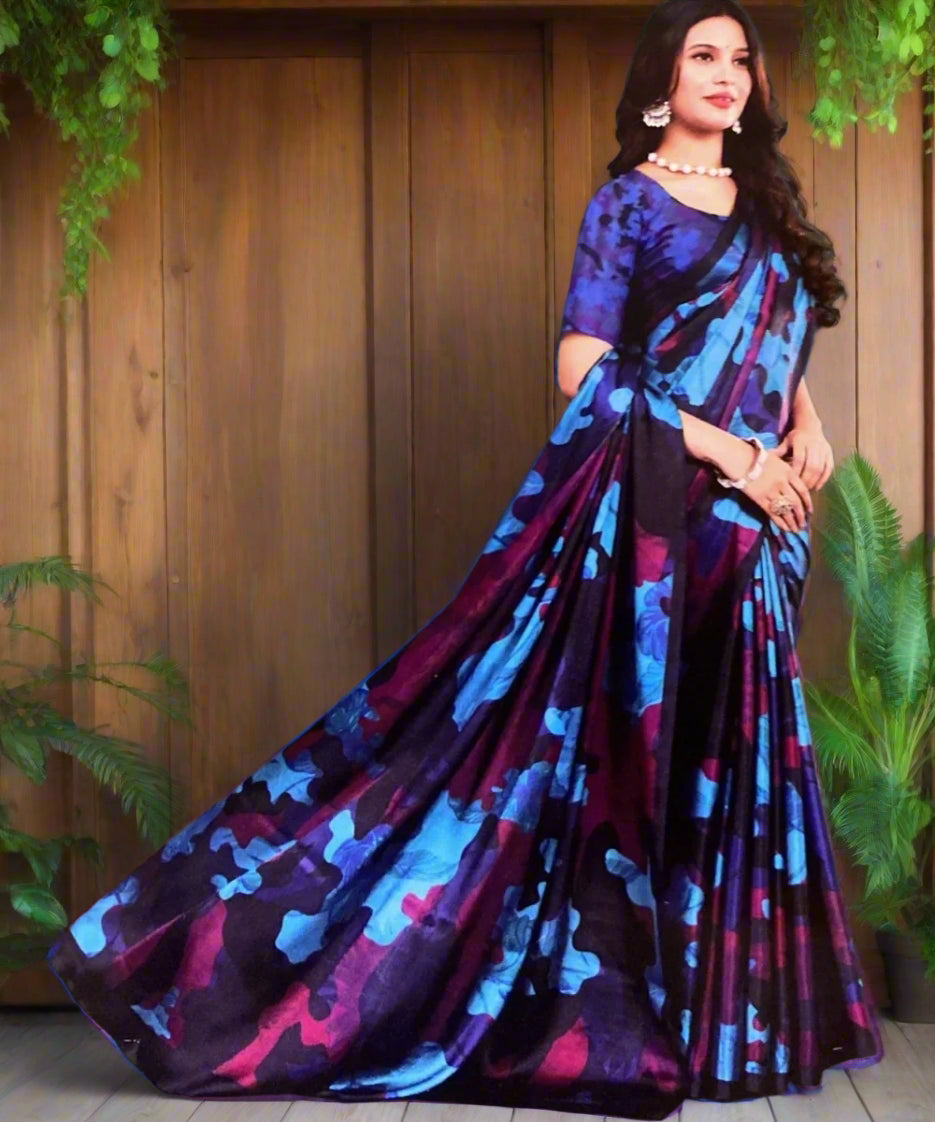 Woman wearing a multi colored patterned saree against a gray background