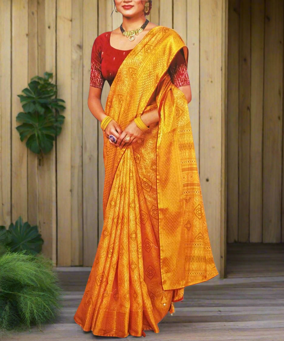 Woman wearing a yellow saree with a red blouse.