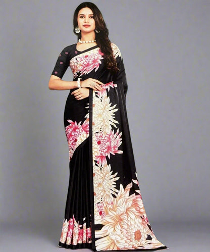 Woman wearing a black formal saree with floral patterns.