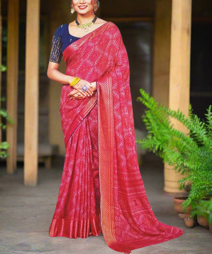 Woman wearing a pink saree with a white border perfect for festive occassions.