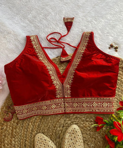 Back side of beautiful embellished red blouse.