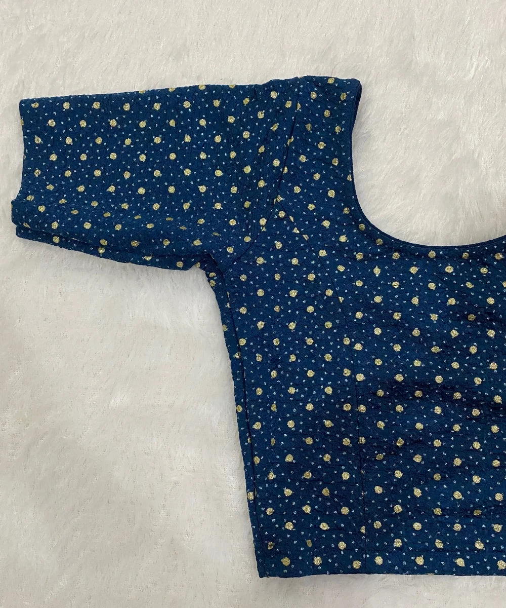 Blue stretchable blouse with gold polka dots on a white background