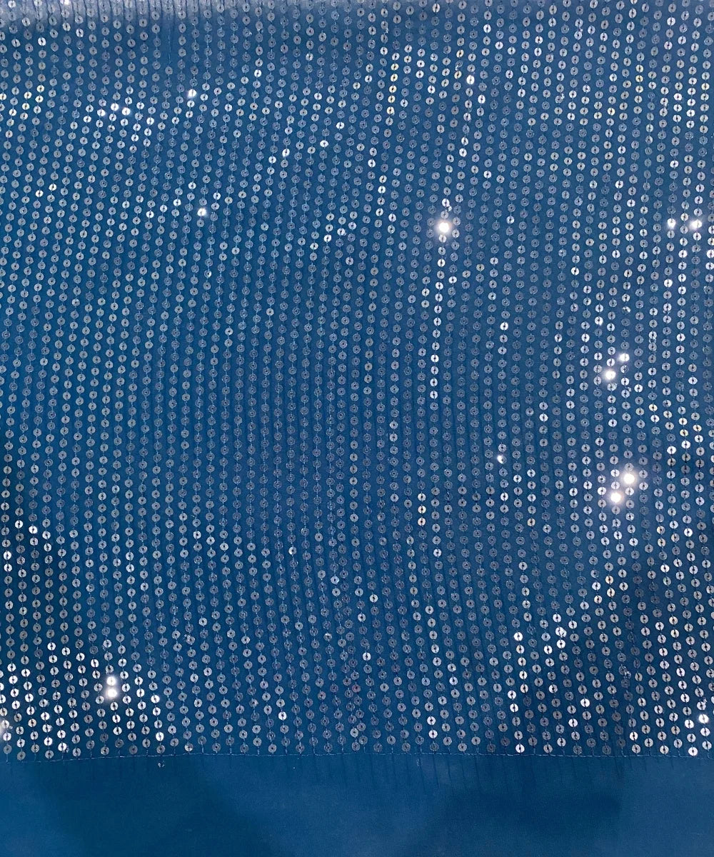 Close-up of blue fabric with silver sequins