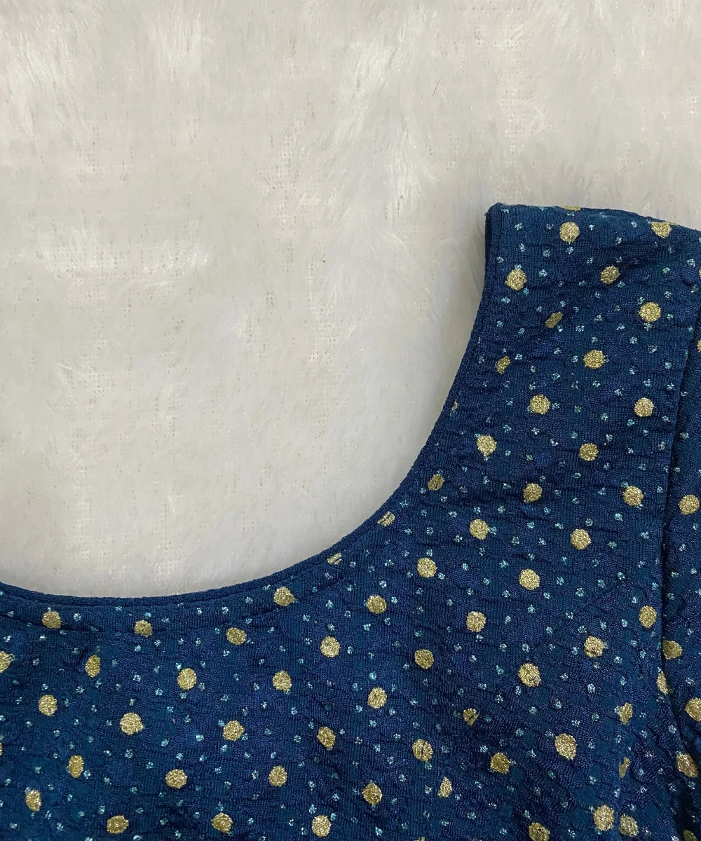 Blue patterned stretchable blouse in cotton material on a light gray background.