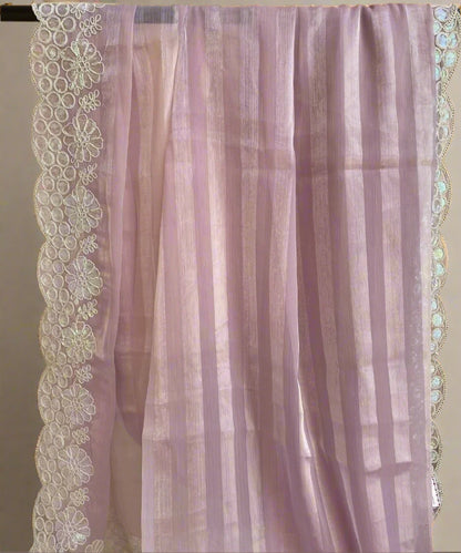 A purple floral saree with self-striped design and floral border detailing, displayed on a light background.