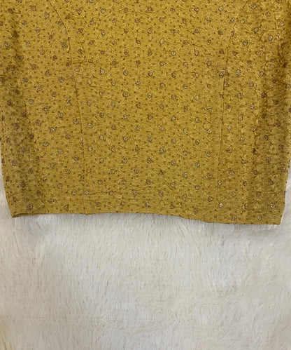 Close-up of a cotton stretchable blouse with a subtle pattern on a white background.