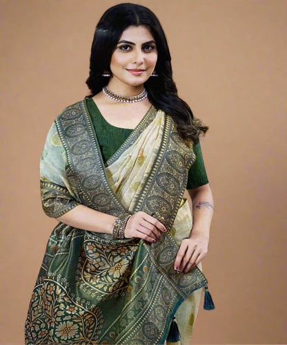 Woman wearing a traditional green and beige saree with a patterned blouse against a brown background