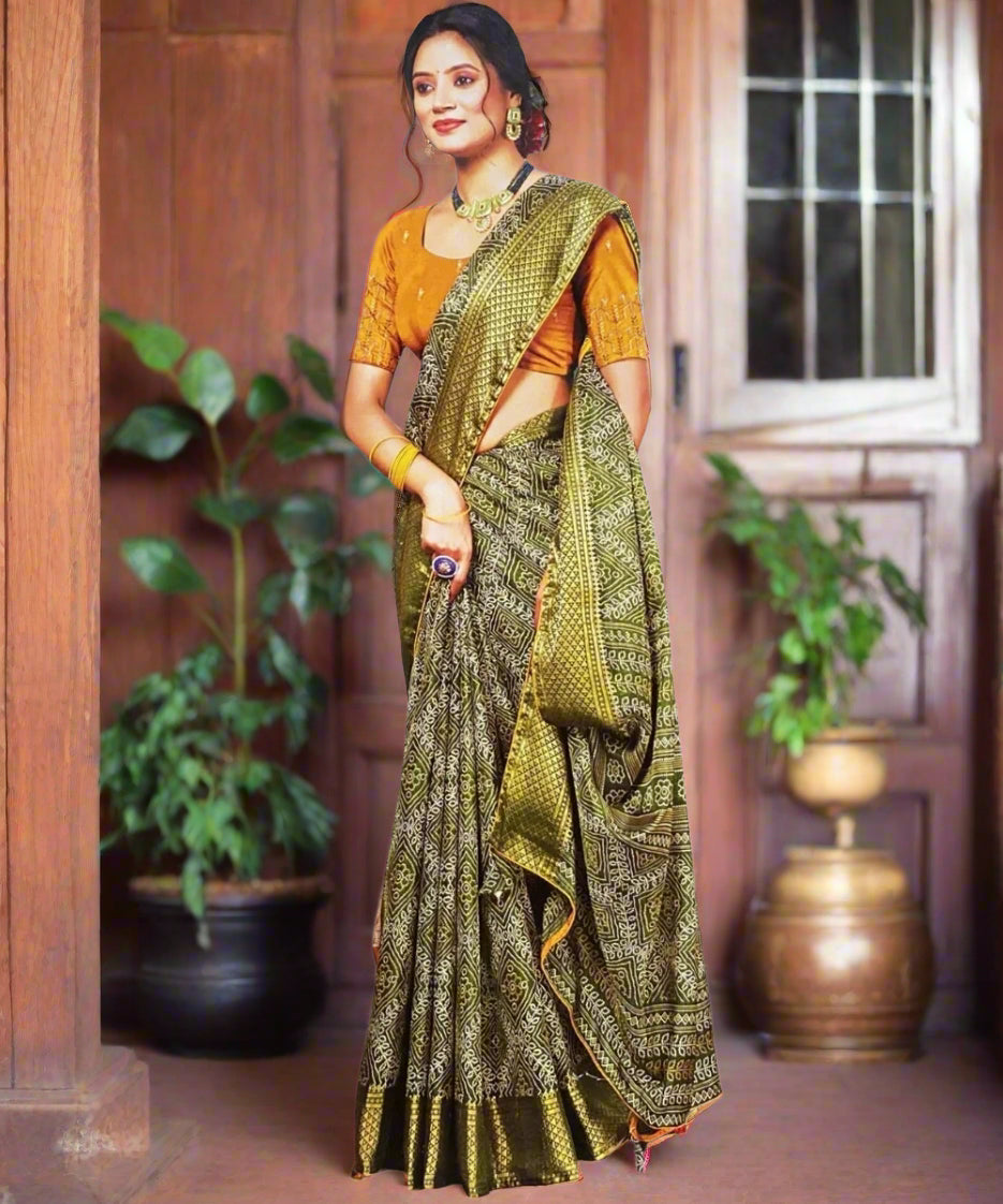 Woman wearing a green and gold saree perfect for navratri.