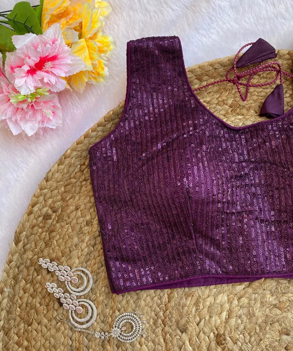 Closeup view of a purple colored party wear sequins blouse.