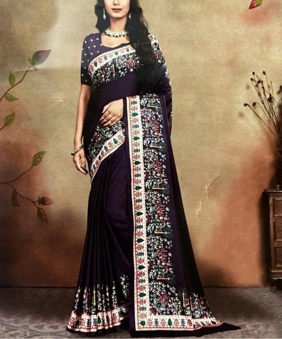 Woman wearing a traditional saree with intricate patterns against a neutral background