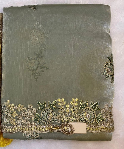 Mehendi  Green saree with intricate gold embroidery and a yellow flower.