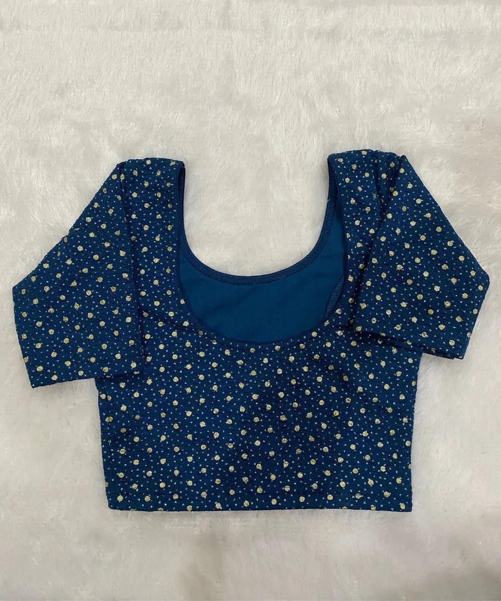 Blue stretchable blouse with gold polka dots on a white background