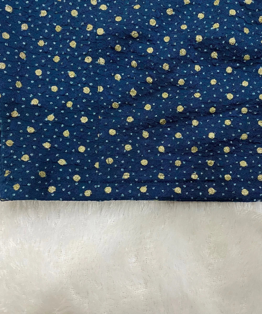 close-up of stretchable blouse with gold polka dots on a white background