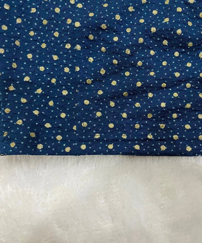 close-up of stretchable blouse with gold polka dots on a white background