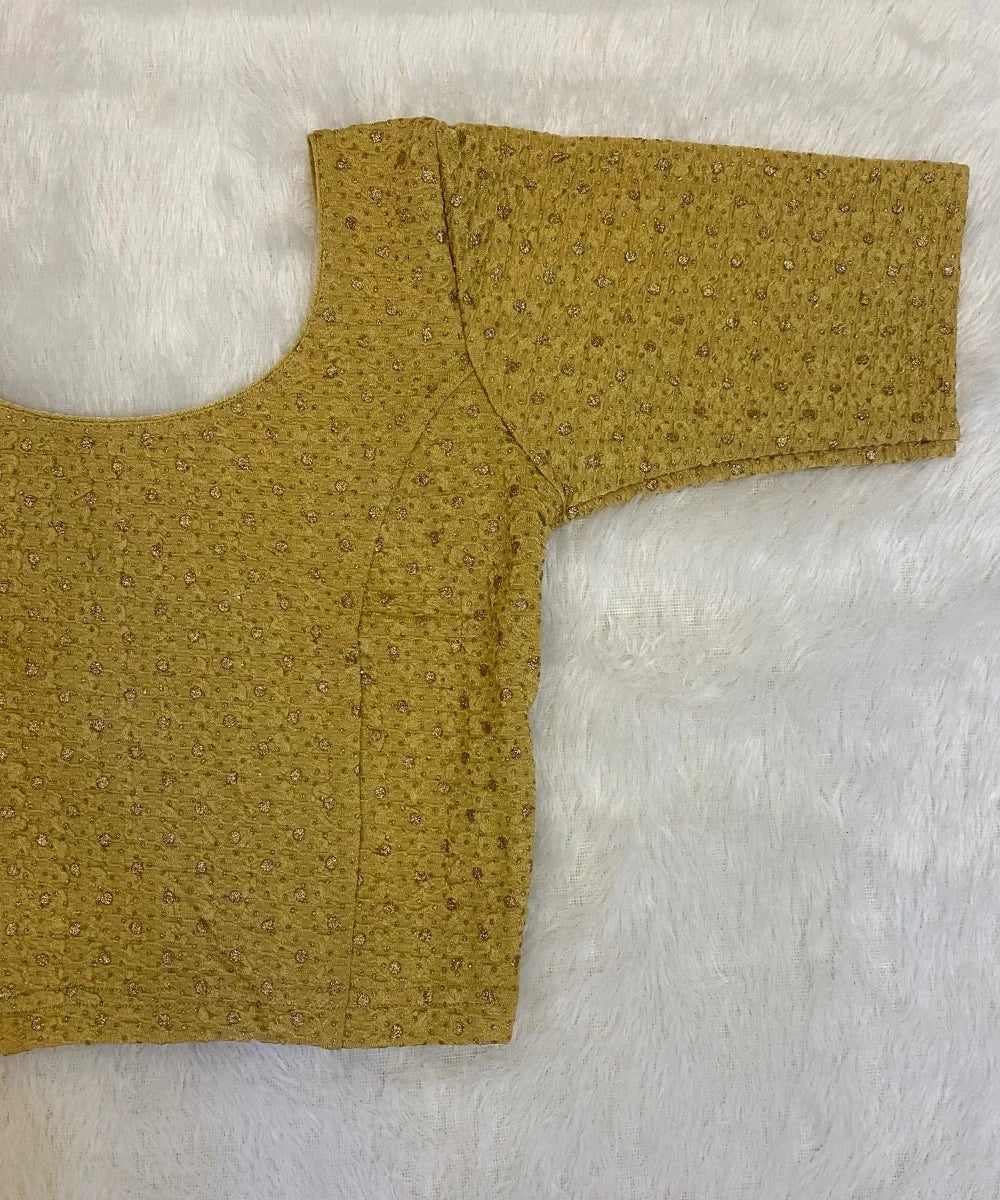 Beige colored cotton stretchable blouse on a light grey background