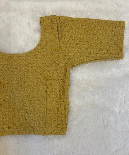 Beige colored cotton stretchable blouse on a light grey background